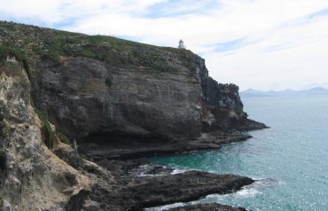 Lighthouse on a cliff overlooking the sea